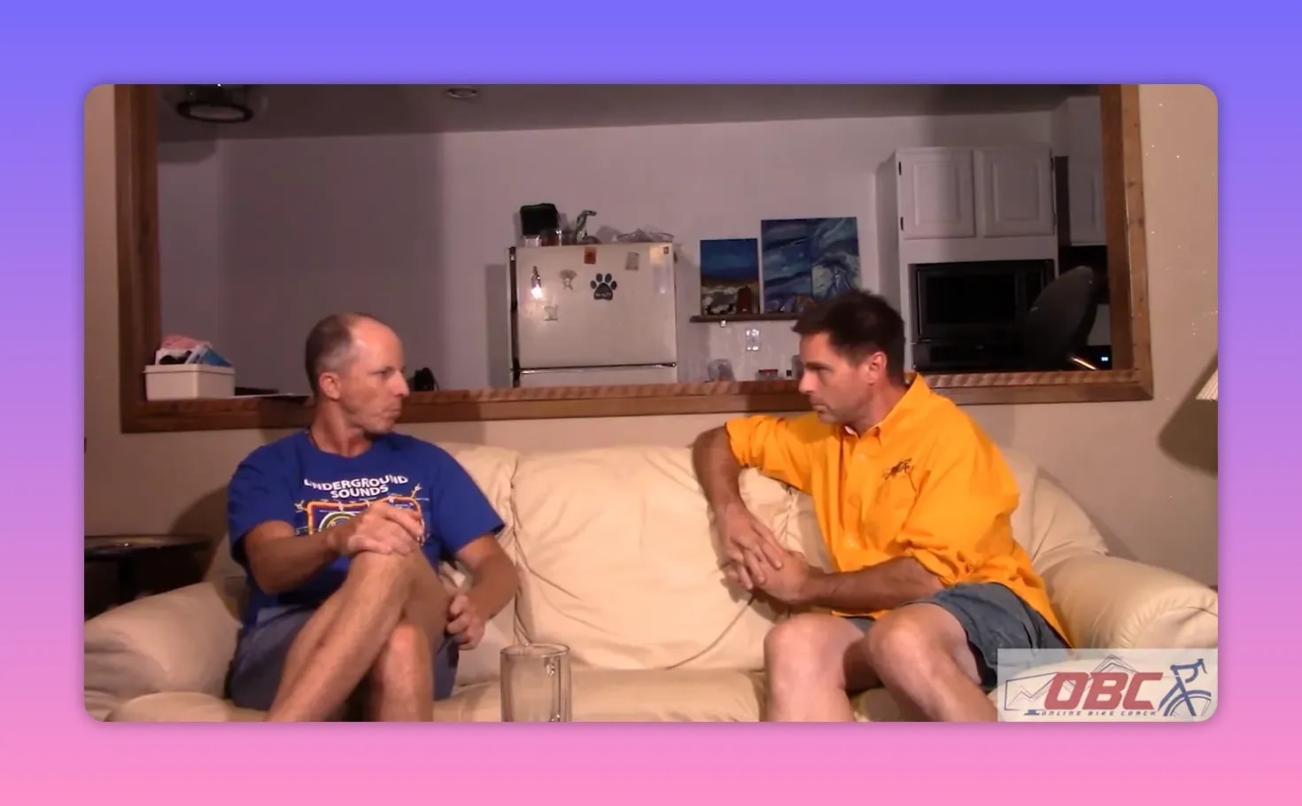 Two people seated on a couch facing each other in an interview, clear shot suitable for illustrating a discussion about models and research