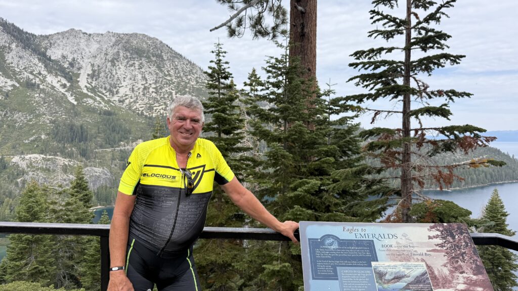 Murray Wilmerding in cycling kit, smiling outdoors during a ride around Lake Tahoe in 2025.