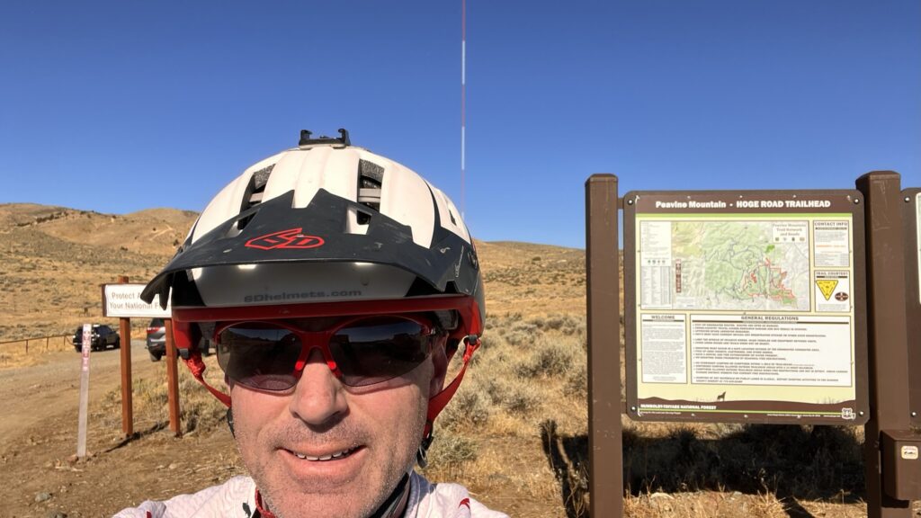 Cycling coach Richard Wharton wearing a helmet at the Peavine Mountain Hoge Road Trailhead before a physiology-first cycling training field test.